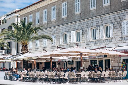 Montenegro, Tivat, April 9, 2019: People sit, eat and communicate with each other in a street cafe.のeditorial素材