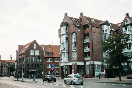 Germany, Muenster, August 17 2018: View of the city street. On the road going car. Crossroads and traffic lights. Typical day.のeditorial素材