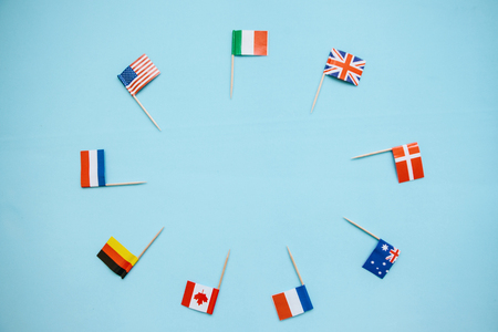 Flags of different countries on a blue background. Concept of friendship between countries and cooperation.の写真素材
