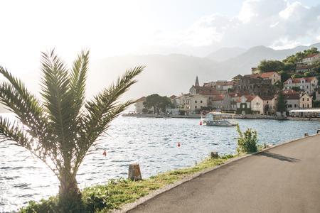 Beautiful view of the ancient architecture in Perast in Montenegro. Boat in the sea and mountains in...
