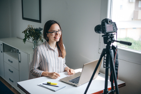 Girl blogger records video for their subscribers. Infobusiness or information business or hobby or online training or education for people.の写真素材