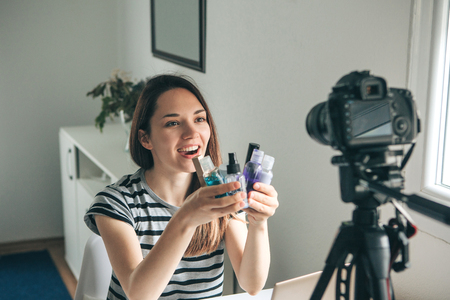 A beauty blogger or video blogger tells and shows subscribers how to do makeup.の写真素材