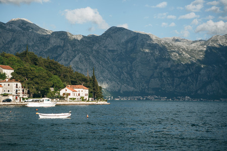 Beautiful view of the old coastal town of Perast in Montenegro with beautiful architecture, the sea and boats on the background of the mountains.の写真素材