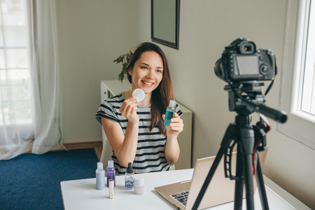 A beauty blogger or video blogger tells and shows subscribers how to do makeup.の写真素材