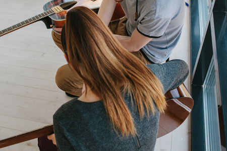 Learning to play the guitar. Extracurricular activities or tutoring or hobbies or creative activities.の写真素材