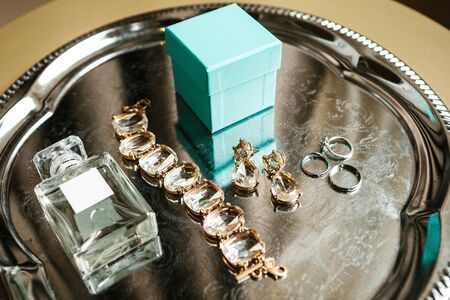 Various wedding accessories, including wedding rings, bracelet and perfume.の写真素材