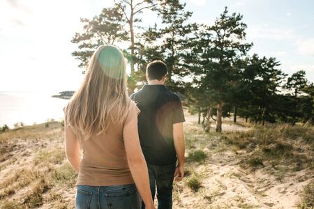 The couple walks together in a natural landscape. Traveling together or walking.の写真素材
