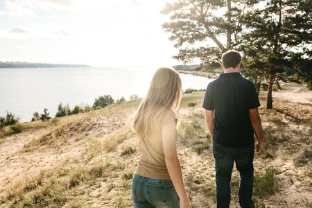The couple walks together in a natural landscape. Traveling together or walking.の写真素材