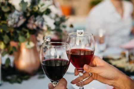 Closeup of hands with glasses of red wine.の写真素材