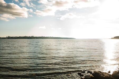 Beautiful view of the sea or the pond and sunset sky. Natural landscape.の写真素材