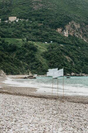 View of the turbulent sea in windy weather or strong wind. White flags indicate that the wind is strong.の写真素材
