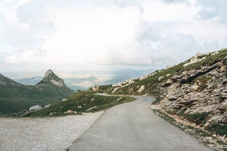 Beautiful view of the mountainous natural landscape in Montenegro. View of the mountains and the asphalt road through the valley.の写真素材