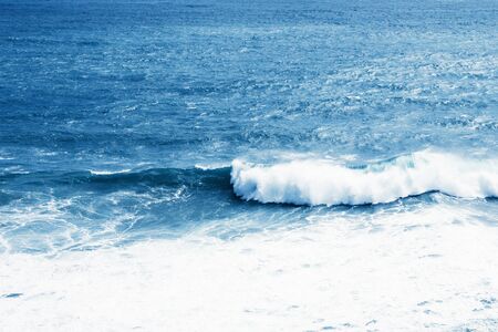 View of the blue sea or ocean with foam and waves background.の写真素材