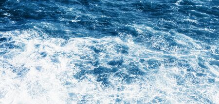 View of the blue sea or ocean with foam and waves background.の写真素材