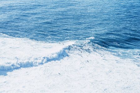 View of the blue sea or ocean with foam and waves background.の写真素材
