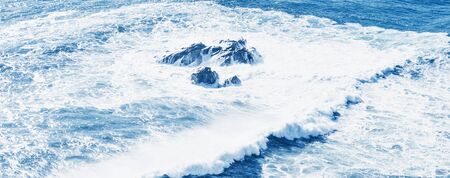 View of the blue sea or ocean with foam and waves background.の写真素材