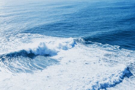 View of the blue sea or ocean with foam and waves background.の写真素材