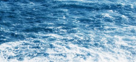 View of the blue sea or ocean with foam and waves background.の写真素材