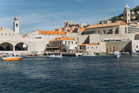 Beautiful view of traditional old buildings and boats in the old town in Dubrovnik in Croatia.の写真素材