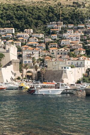 Beautiful view of traditional old buildings and boats in the old town in Dubrovnik in Croatia.の写真素材