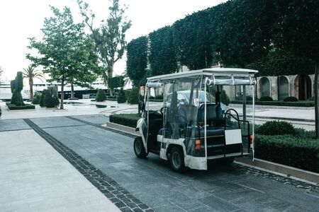View of the street in Tivat in Montenegro. A tourist electric car is parked on the street.の写真素材