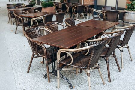 Empty tables and chairs of a street cafeの写真素材