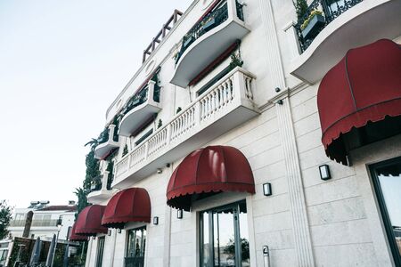 Frontal view of a typical residential building with many balconies and windowsの写真素材