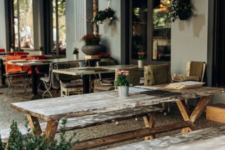 Empty street cafe with wooden tables. Waiting for customers.の写真素材