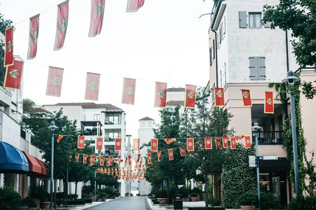 A street in Tivat in Montenegro decorated with national flags for a holiday or celebration.の写真素材