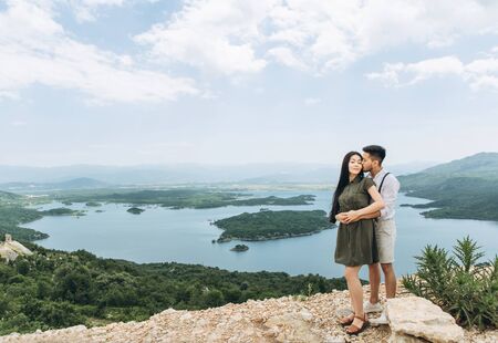 A young couple hugs and a man kisses a woman.の写真素材