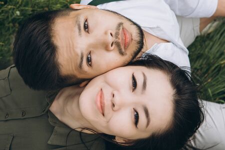Close up of a young beautiful couple looking up and dreaming. Male and female faces nearby or together.の写真素材