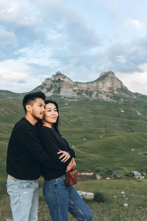 Young beautiful couple hugs on a background of a mountain landscape in Montenegro.の写真素材