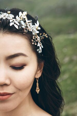 Close up portrait of half face of bride with closed eyes and smile.の写真素材