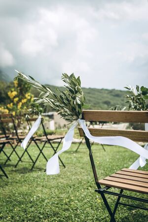 Decorated chairs at a wedding event. Outdoor wedding.の写真素材