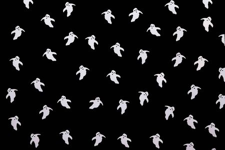 White funny ghosts on a black background. Halloween celebration background.の写真素材