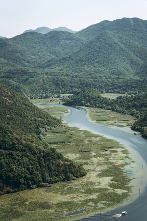 Beautiful natural mountainous or hilly landscape and the bend of the river Crnoevich on Skadar Lake in Montenegro. One of the natural attractions of the country.の写真素材