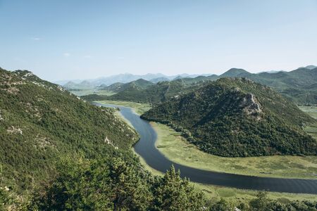 Beautiful natural mountainous or hilly landscape and the bend of the river Crnoevich on Skadar Lake in Montenegro. One of the natural attractions of the country.の写真素材