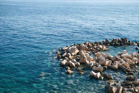 Concrete blocks or breakwaters on the seashore or concrete heavy structures on the shore near the sea.の写真素材