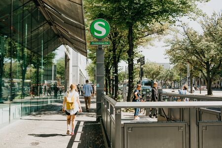Germany, Berlin, August 14, 2019: City street. People go about their business near the entrance to the subway.のeditorial素材