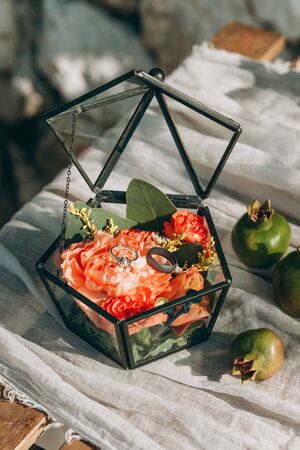 Close up of wedding or engagement rings in a box decorated with flowers.の写真素材