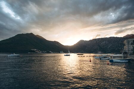 Beautiful view of the Kotor Bay in Montenegro at sunset. Natural mountain landscape and sea with boats or yachts. Near the small town of Perast.の写真素材