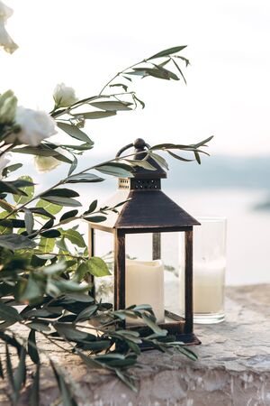Close-up of a candle in a candlestick as a decoration. Near the flowers.の写真素材