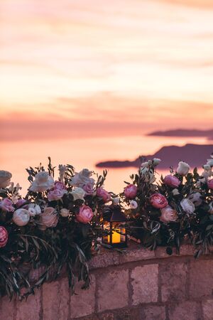 Candles and flowers as decorations in the evening.の写真素材
