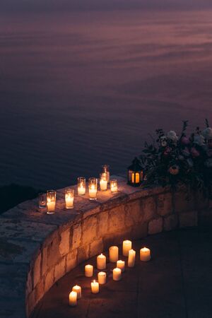 Candles and flowers as decorations in the evening.の写真素材
