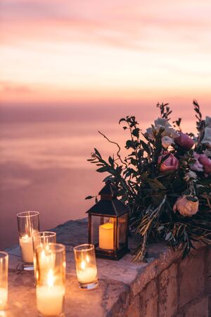 Candles and flowers as decorations in the evening.の写真素材