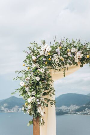 Close-up of flowers on a wedding arch. Preparation for a wedding event.の写真素材