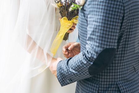 The groom or husband puts the ring on the bride or wife of the wedding ceremony. Wedding event.の写真素材