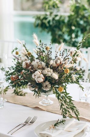 Table decoration for a ceremony or celebration. Beautiful flowers on the table in rustic style.の写真素材