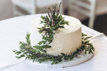 Close-up of a cake decorated with lavender flowers.