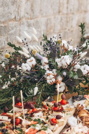 Decoration of flowers on the table with various food or snacks. Catering and table decoration.の写真素材